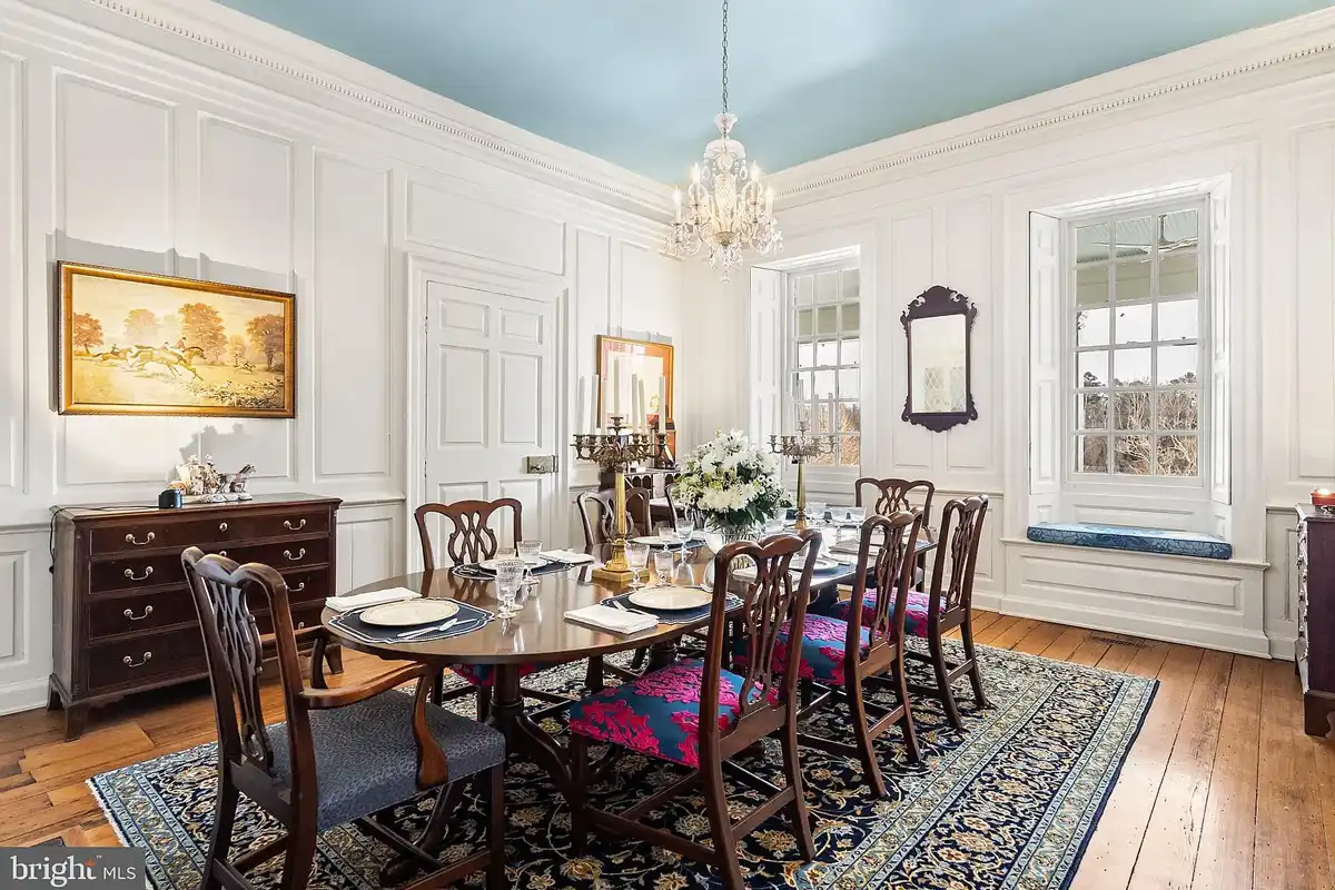 paneled dining room with chandelier