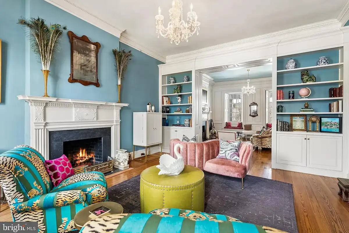 blue sitting room with fireplace and built-in shelves