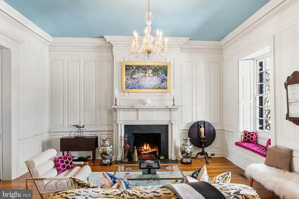 grand parlor with paneled walls and light blue ceiling
