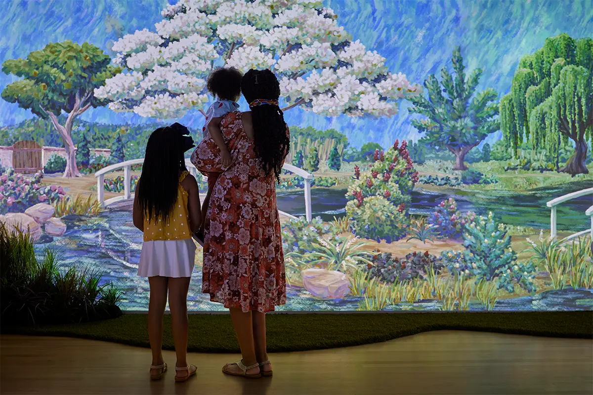 A woman and two children look at a painting at the Jepson Center in Savannah