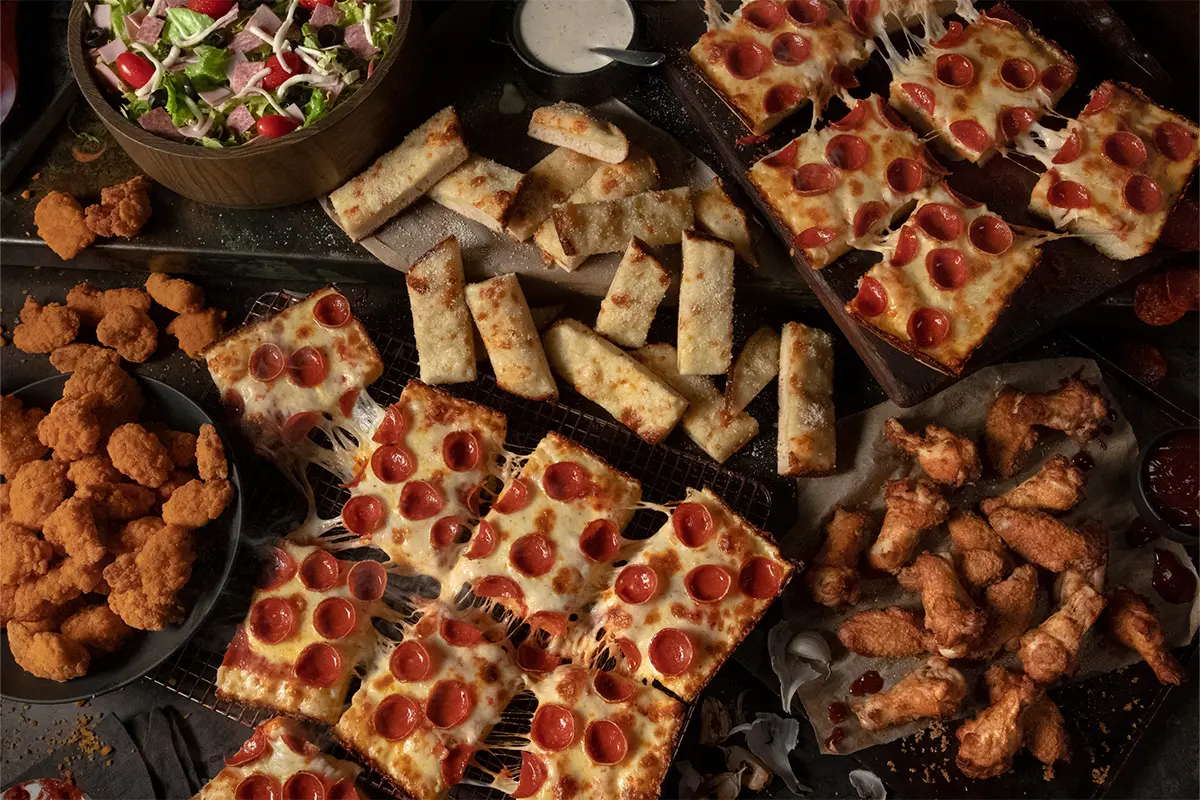 multiple pizzas, appetizers, and salad from Jet's Pizza