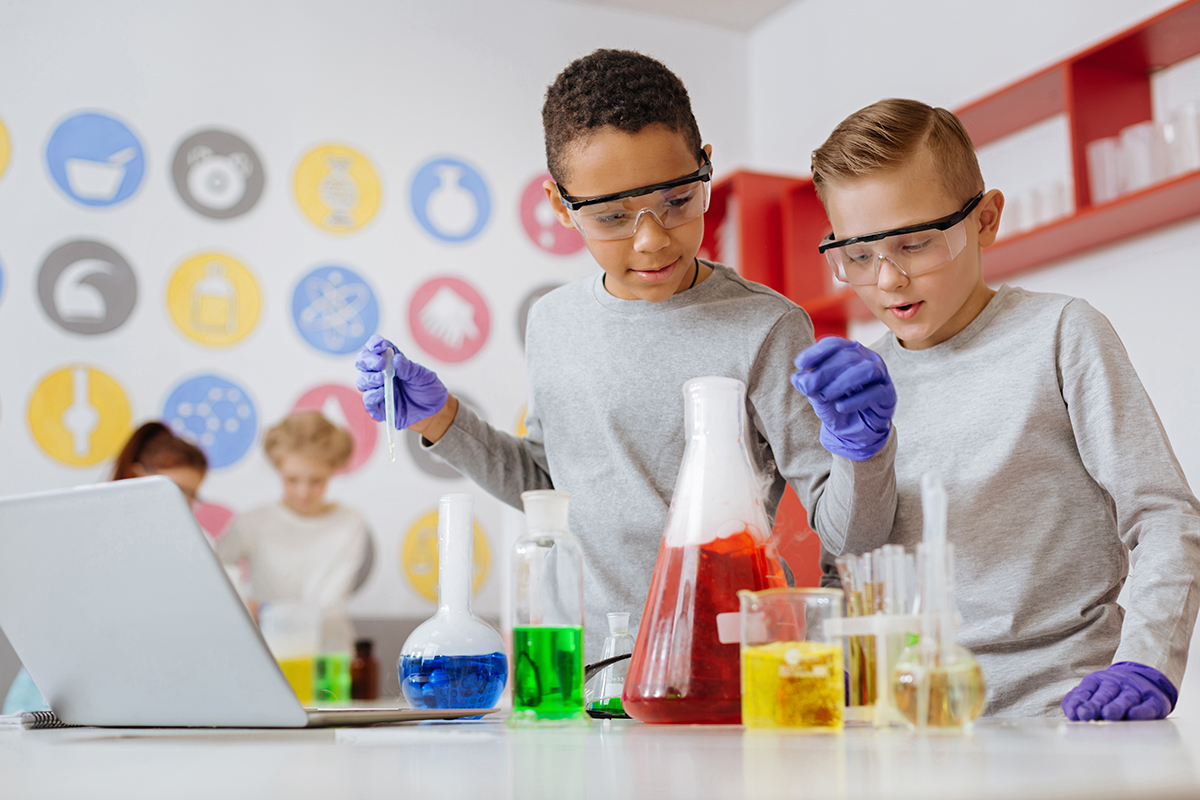 kids doing science experiment with beakers