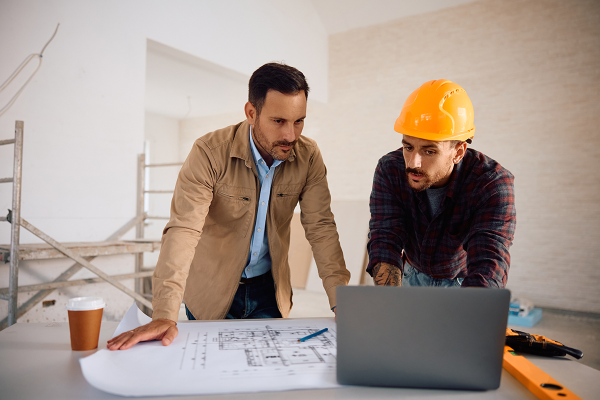 person talking to home expert wearing a hard hat