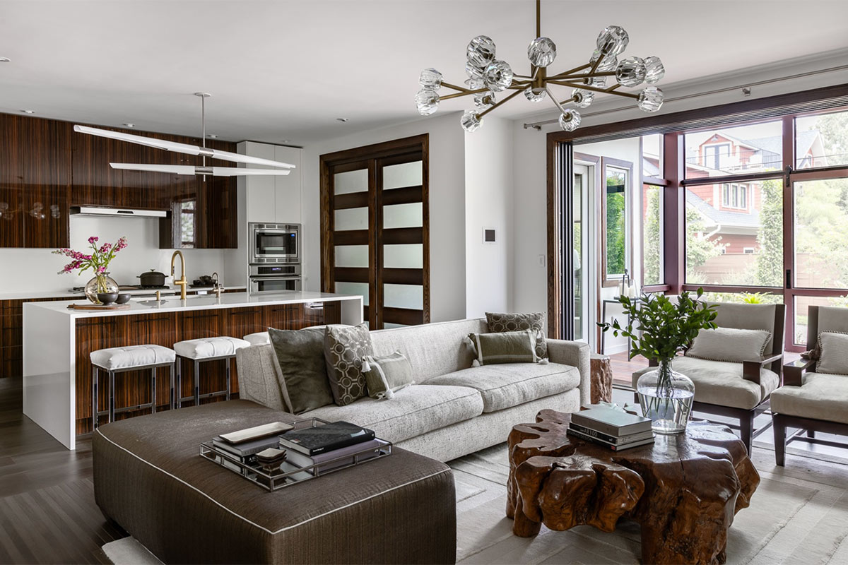 open layout of kitchen and family room with area that leads out to sunroom