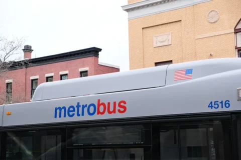 the top of a metrobus with building in the background