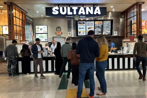 people wait in line outside of the Sultana in the Dulles Town Center