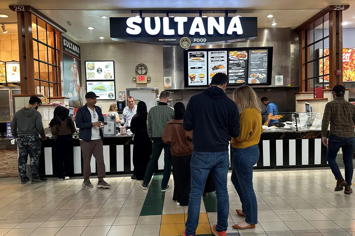 people wait in line outside of the Sultana in the Dulles Town Center