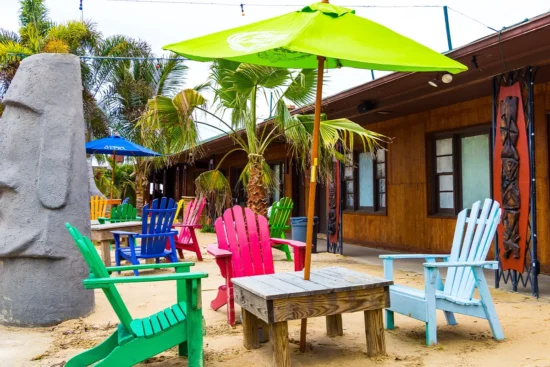 Bright chairs and umbrellas in the sand outside the Tiki Bar & Grill in Solomons Island, Maryland
