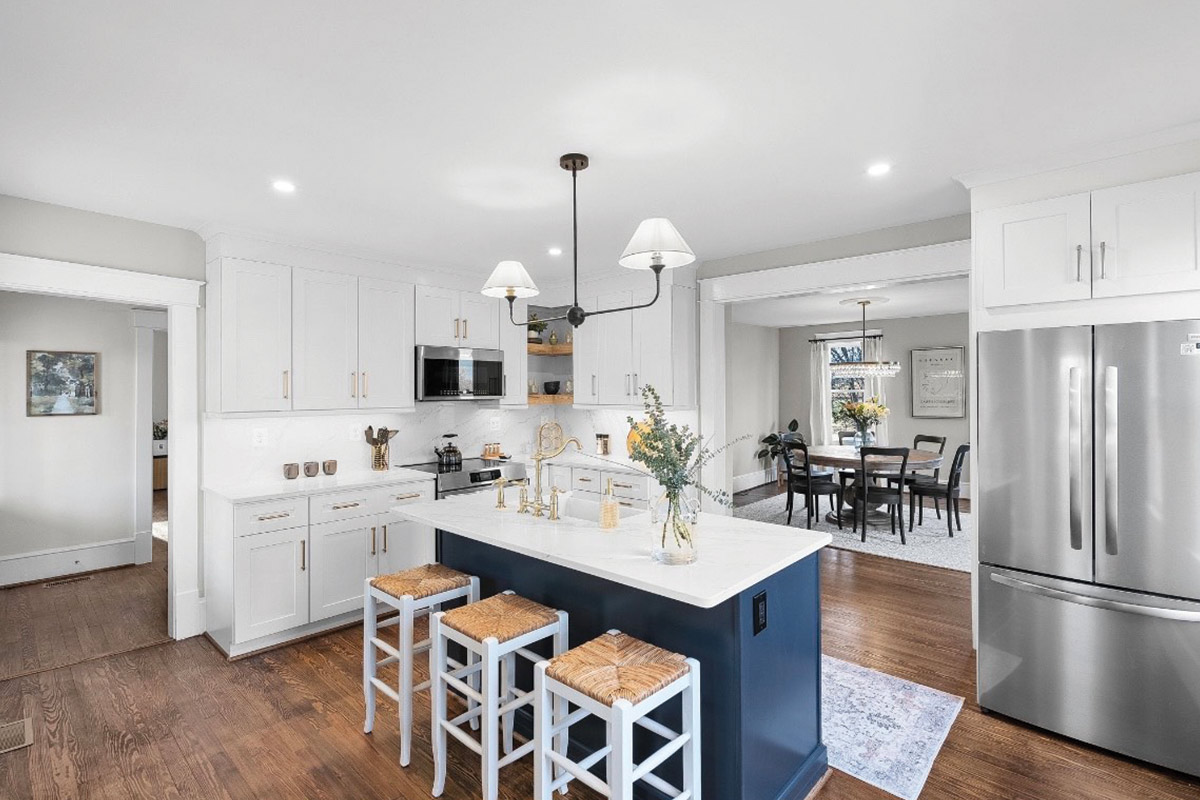 farmhouse kitchen with blue island and white cabinets