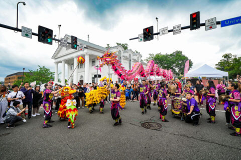 group dancing with dragon at asian festival on main