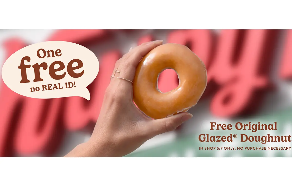 A hand holds a glazed Krispy Kreme Donut to say with a sign "A free no real ID!"