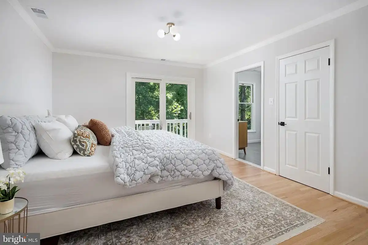 Primary bedroom with access to private balcony