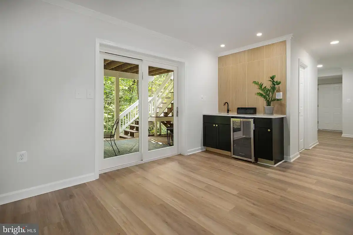 recreation room with wet bar and door to patio