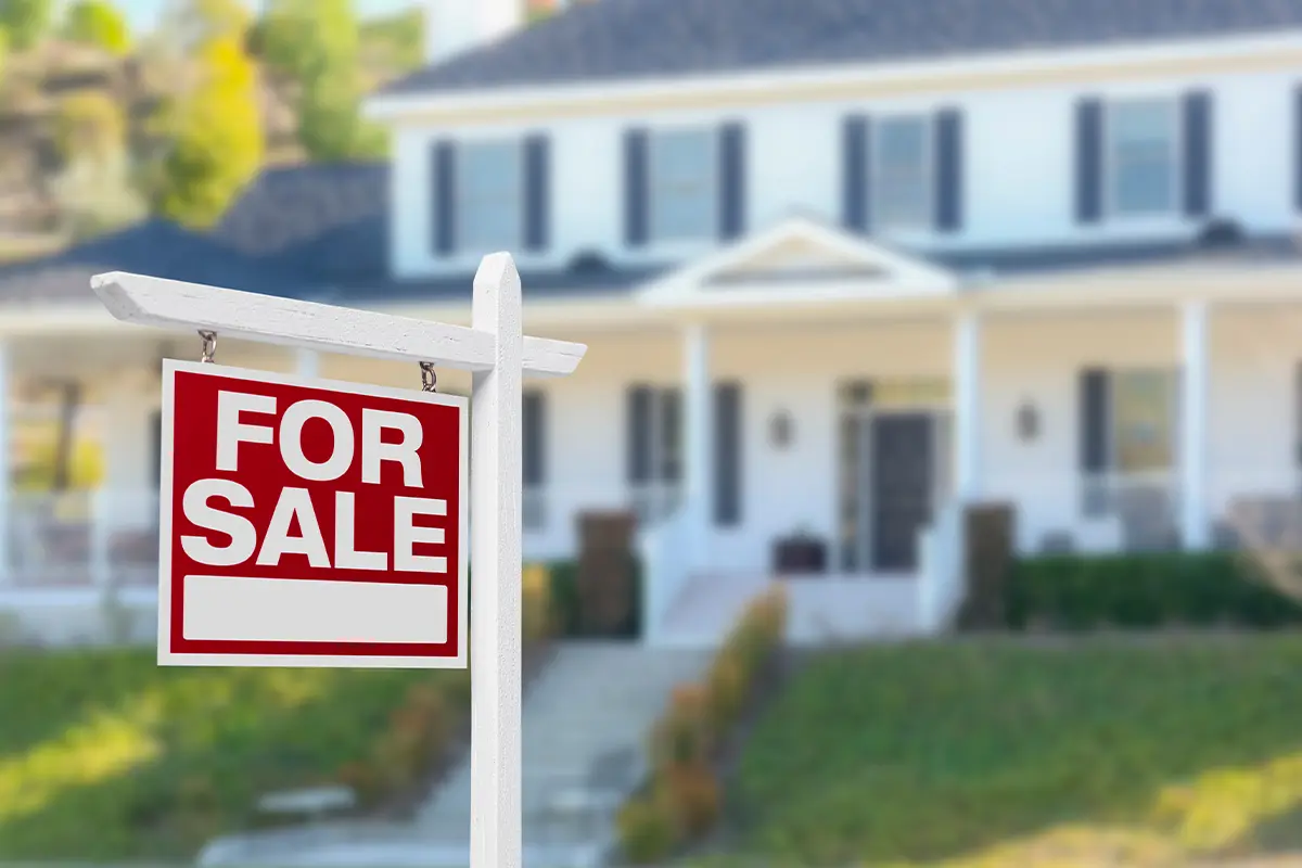 A For Sale sign in front of a home