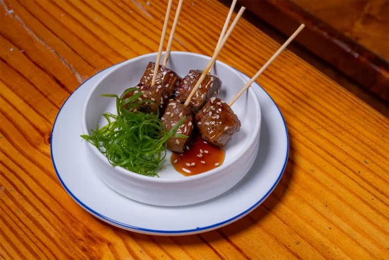Kalbi marinated beef skewers in a bowl