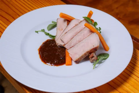 Autumn Olive Farm pork chop with sweet potato and fig gochujang on a plate