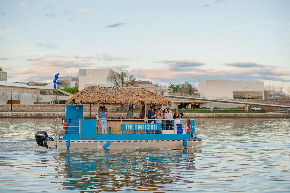 A boat with The Tiki Club signage on the water