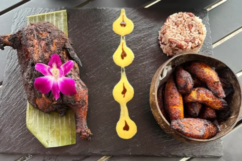a dish of chicken, rice, and plantains at Xaymaca