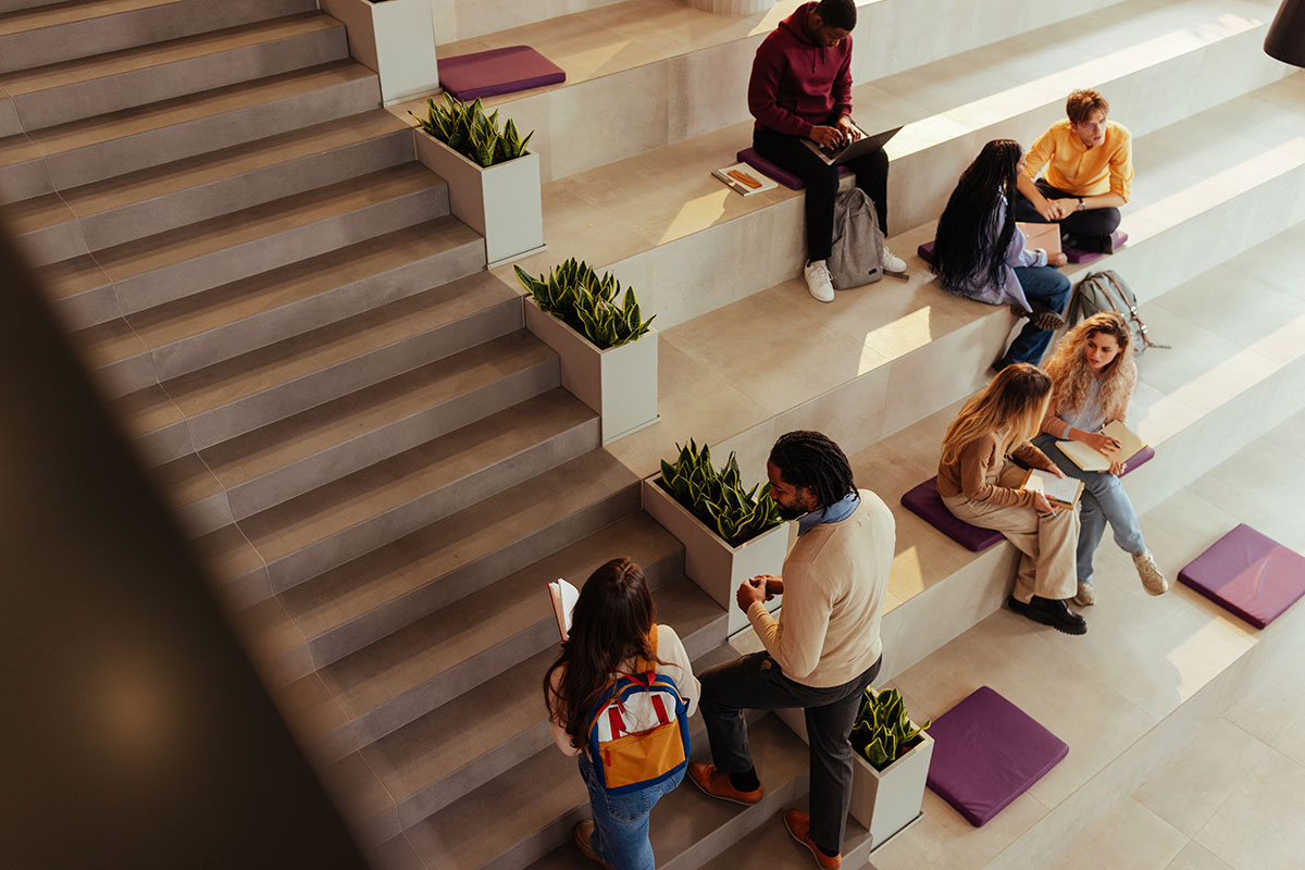group of students talking and walking on steps