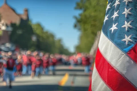 U.S. flag with people walking in the street