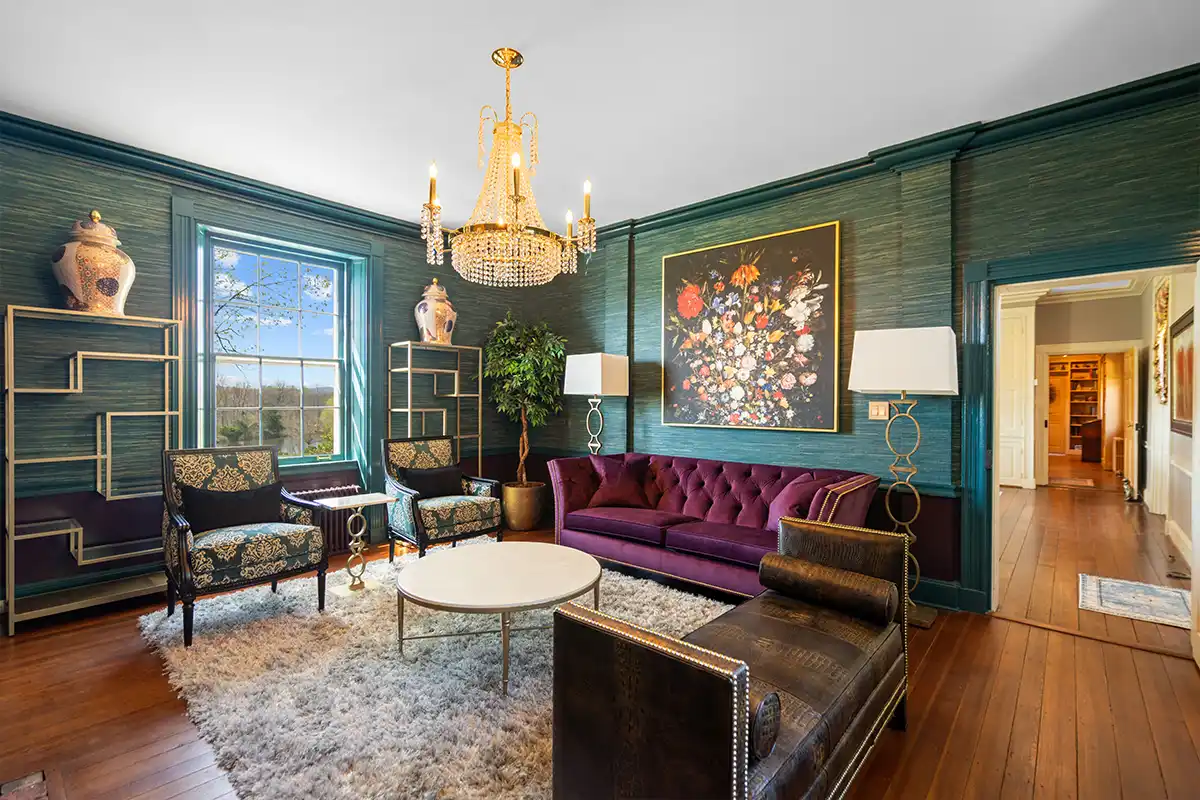 formal sitting room with jewel toned walls and furniture