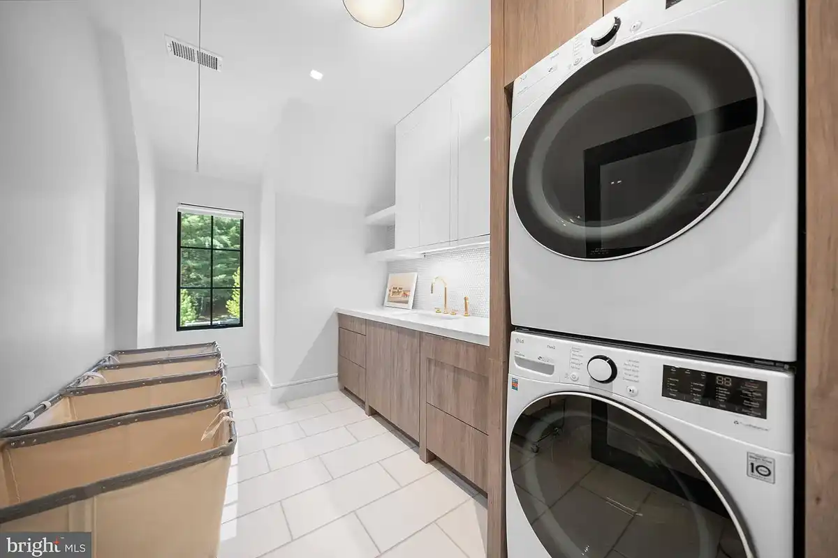 laundry room with stacked washer and dryer