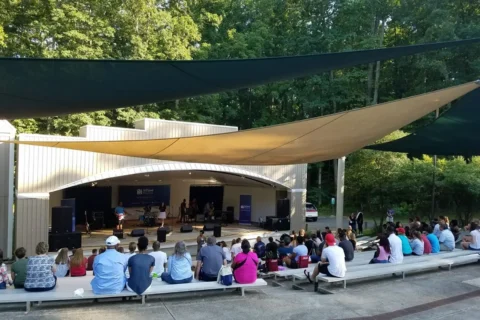 Visitors watch a performance at a Locust Shade Park Pavilion