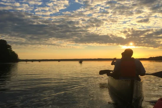 Kayakers on the water view the sunset at Mason Neck Park