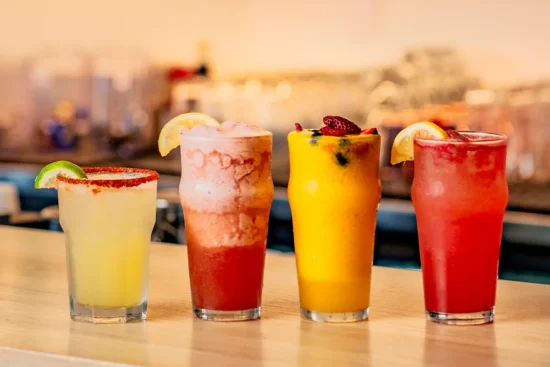 4 cocktails lined up on a table