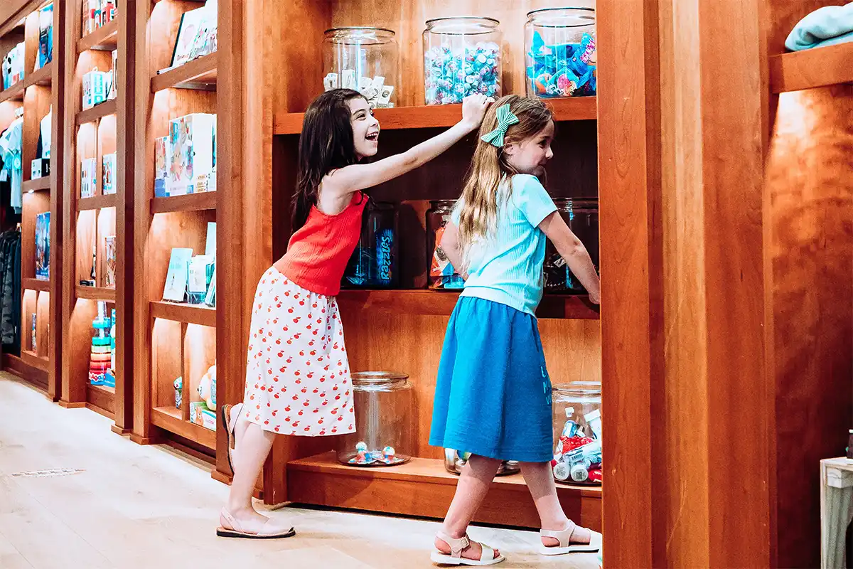 two girls walking through magic door at CAMP in Tysons