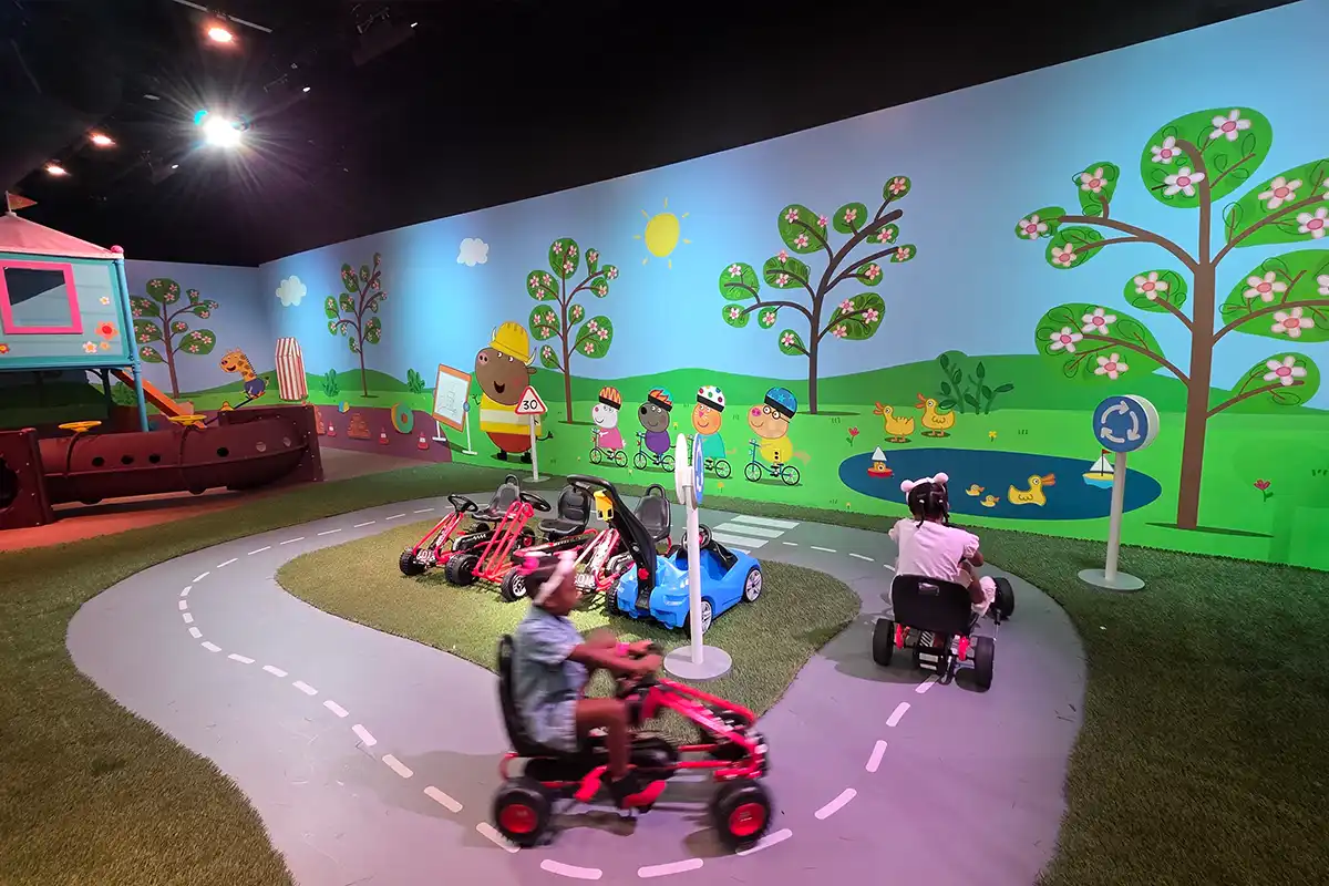 kids riding bikes around track