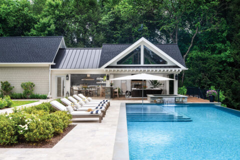in-ground pool with pool house and loungers
