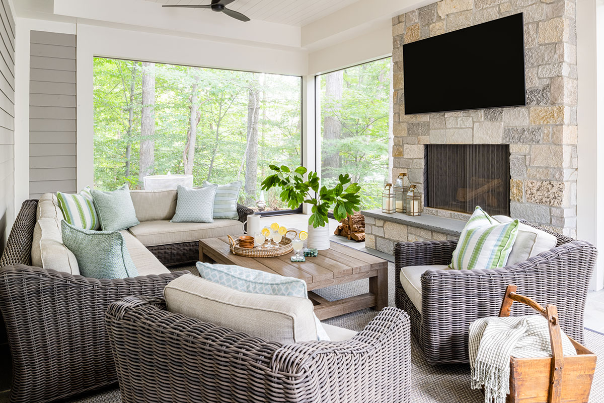 screened-in porch with fireplace and tv