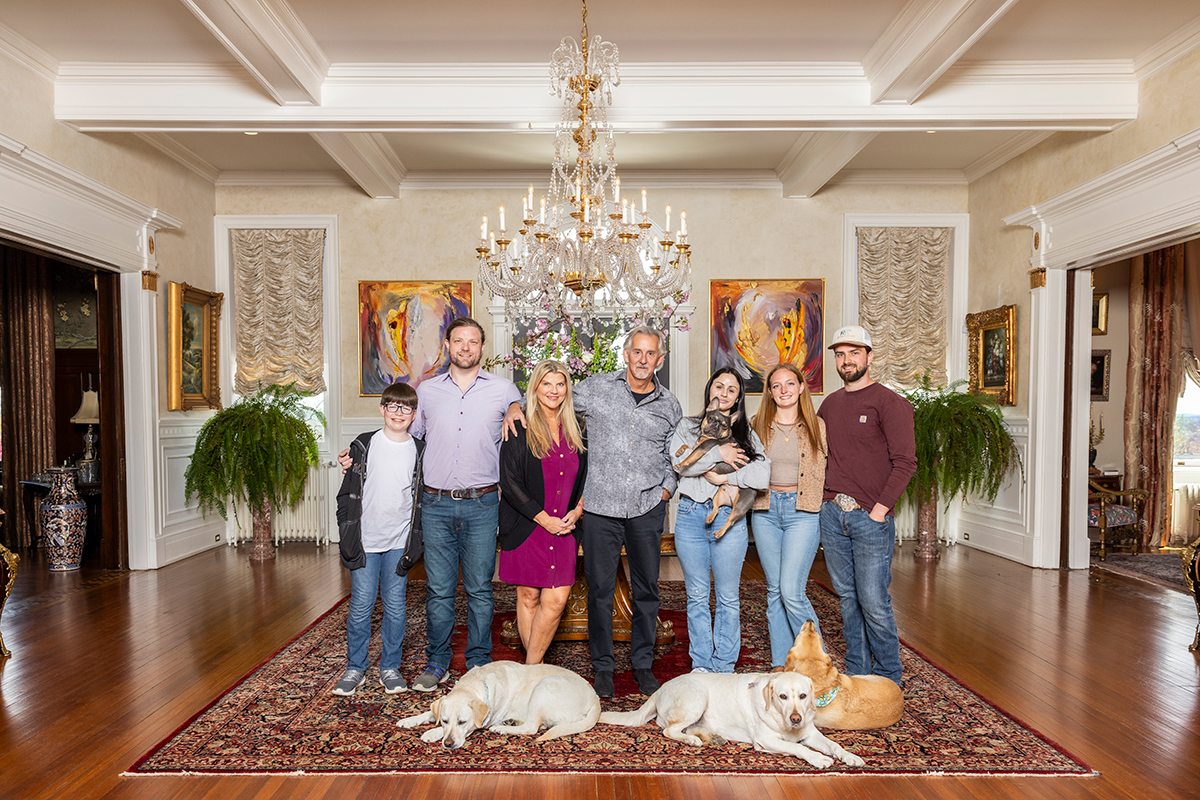 Sharon Virts and Scott Miller pose with their family and dogs