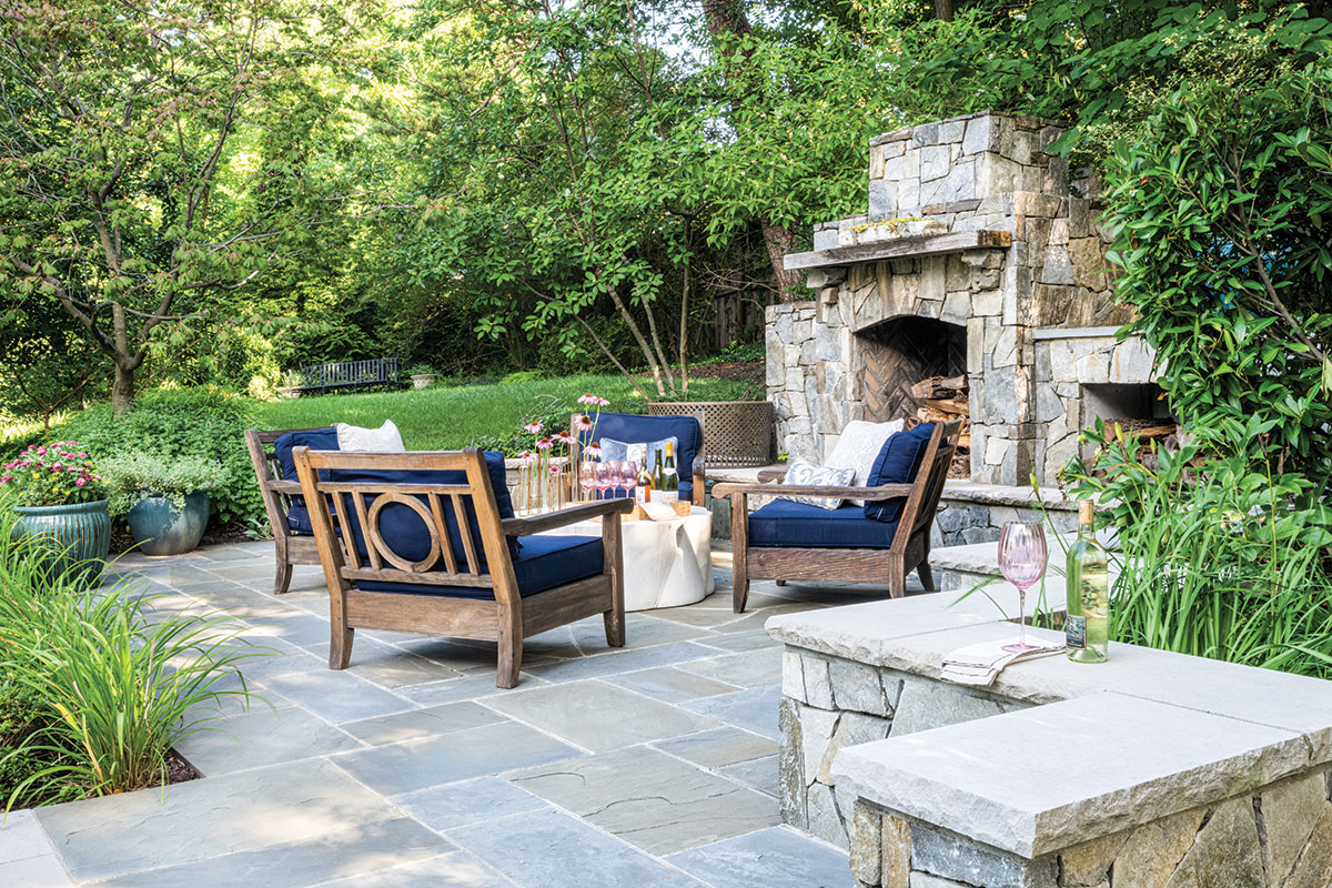 sitting area on stone patio with fireplace