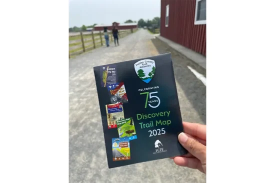 a person holds a 2025 Discovery Trail Map