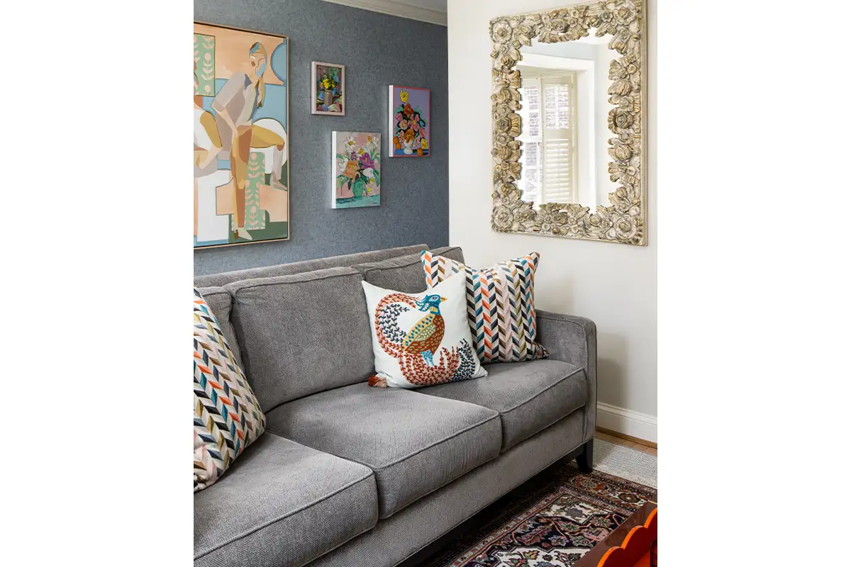 Holly Hunt wallpaper backs the gallery wall in the upstairs den. The mirror is vintage. 