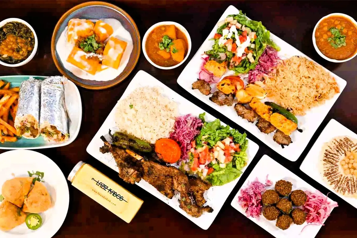 a table full of food at Laziz Kabob