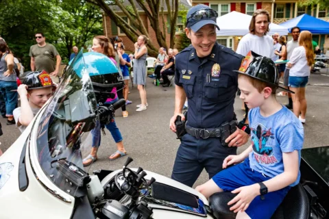 a young boy on a police motorcycle at at National Night Out event in Arlington