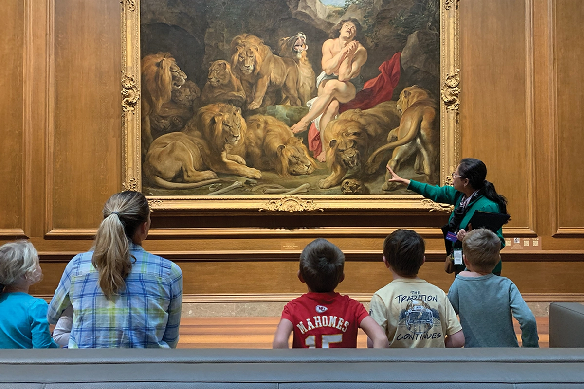 art curator explaining painting to visitors