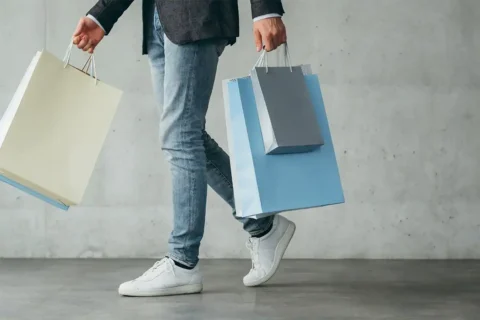man carrying shopping bags