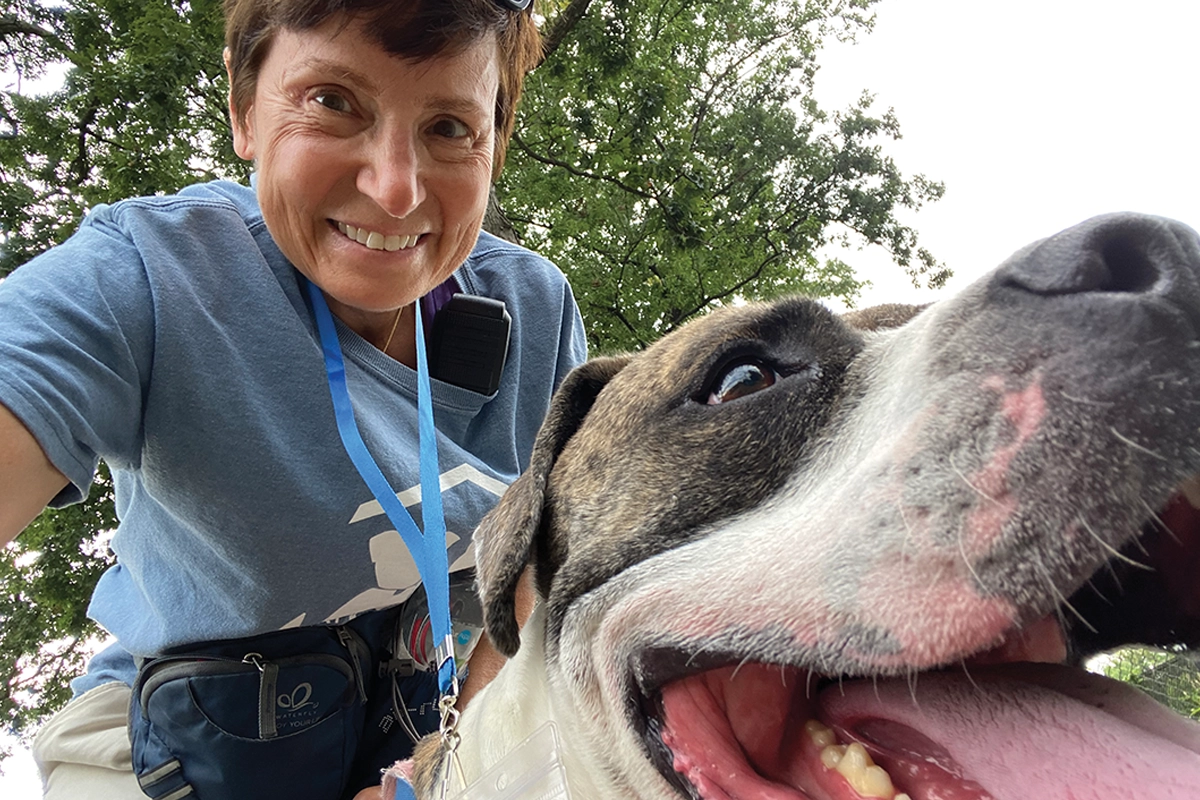 woman volunteering at fairfax animal shelter to walk dog