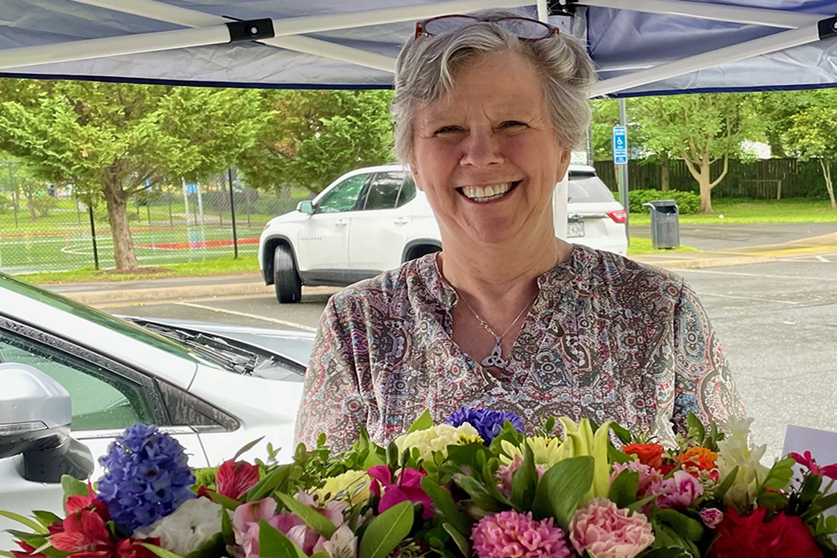 lady smiling around flowers
