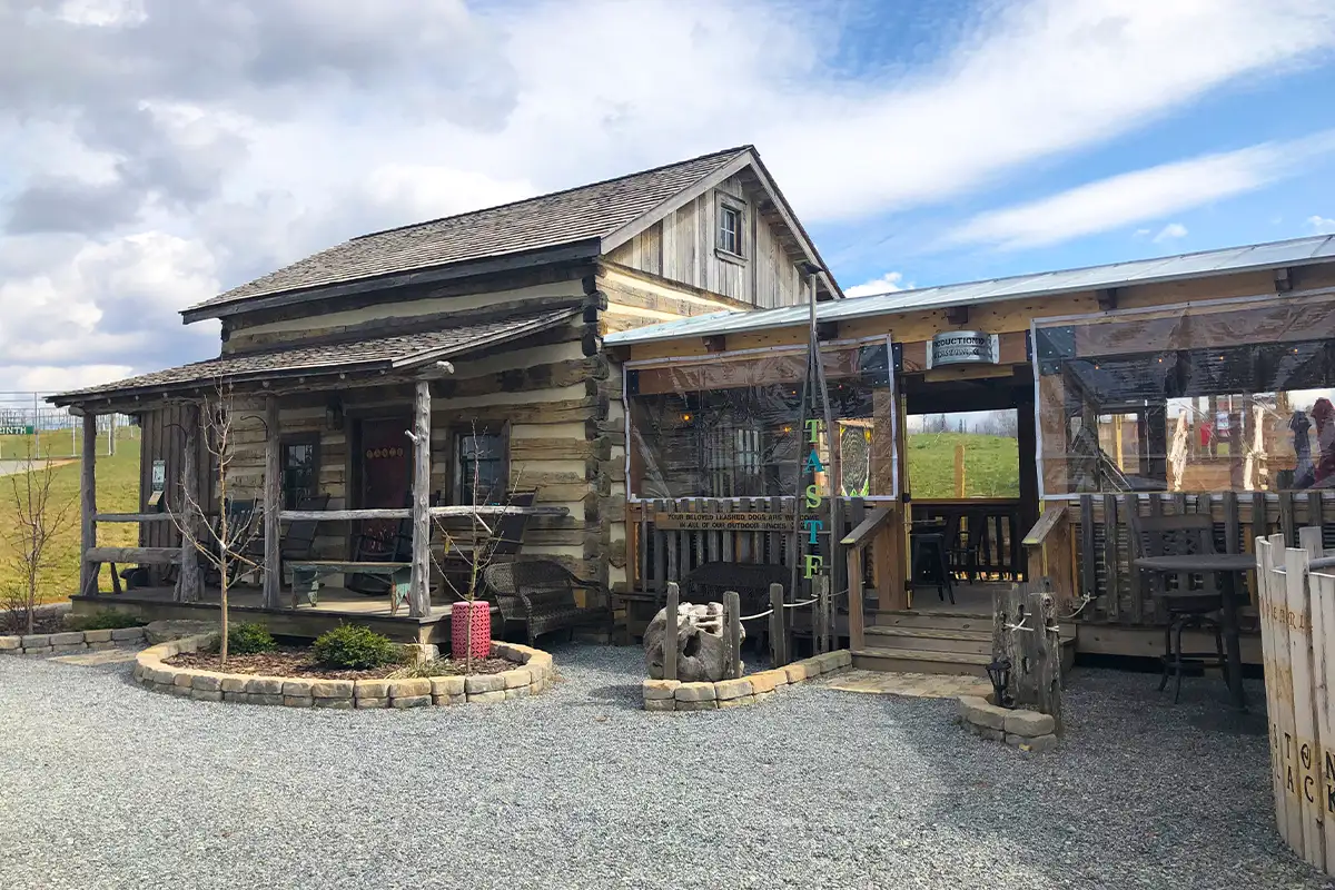 Log cabin-style building at Halcyon Days Cider Co in Lexington