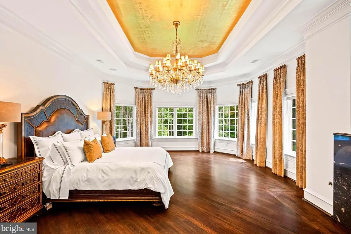 Bedroom with tall ceilings and crystal chandelier