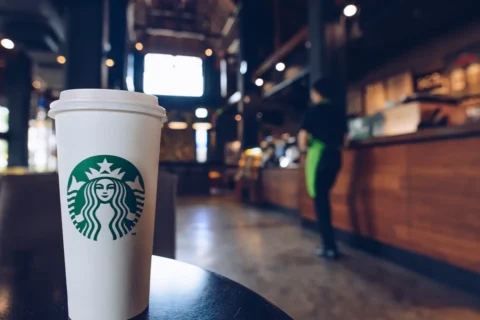 a Starbucks cup in a coffee shop