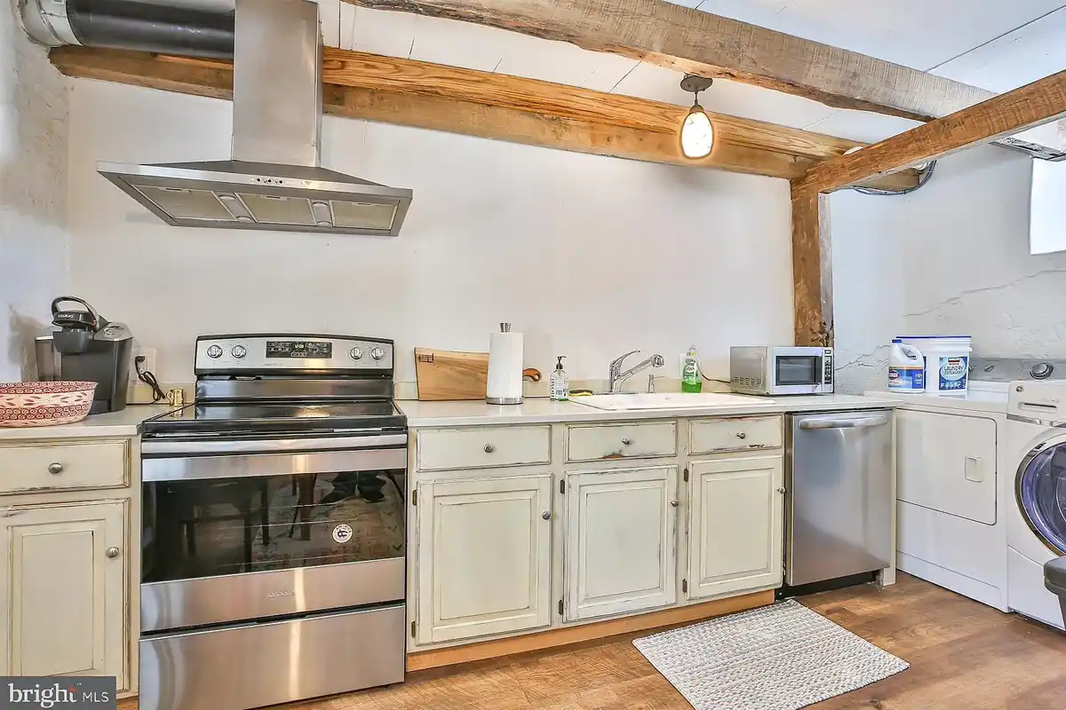 kitchen with rustic cabinets and stainless steel appliances