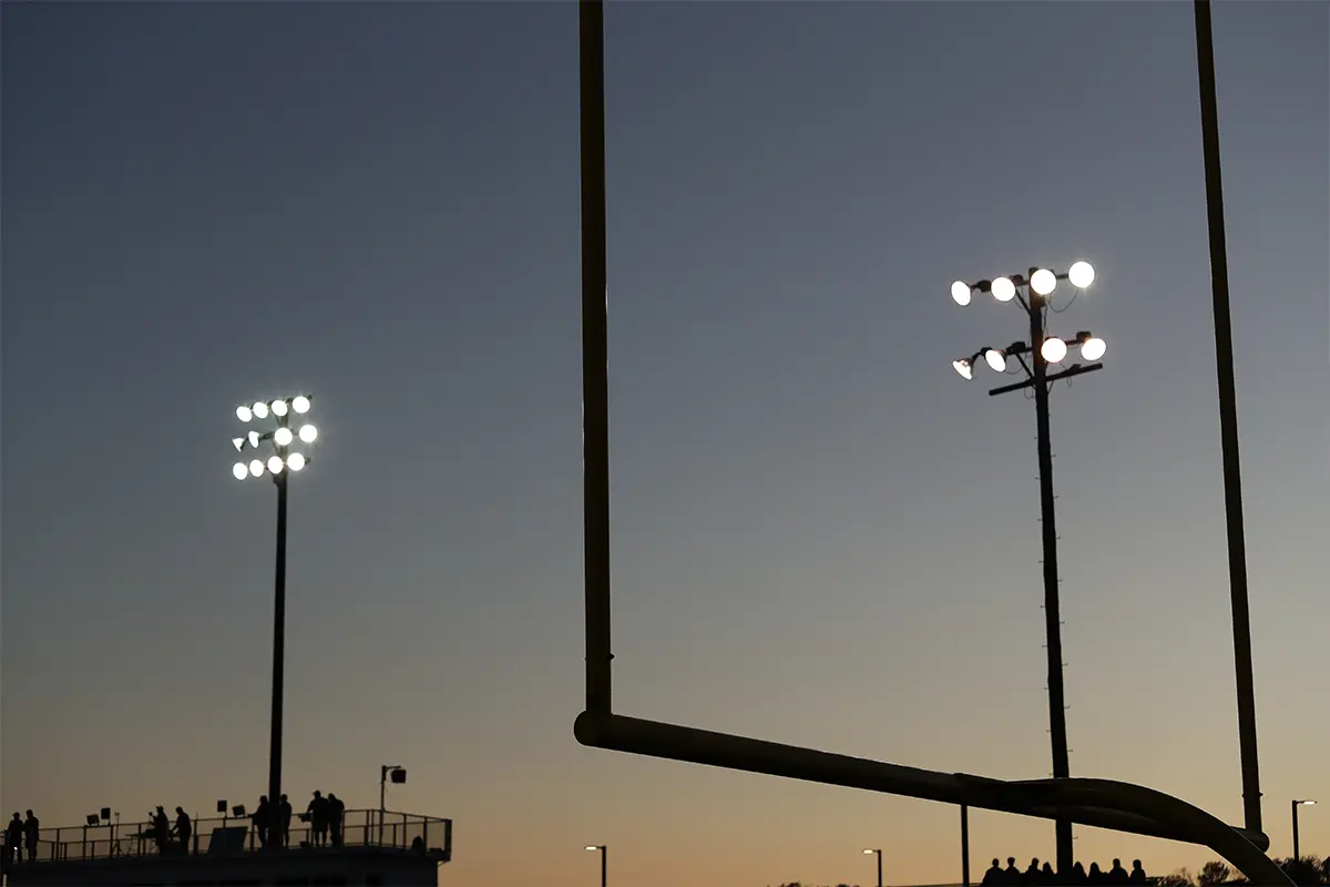 goal posts at a nighttime high school football game