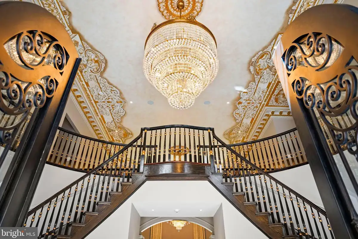 Grand foyer with staircase and crystal chandelier