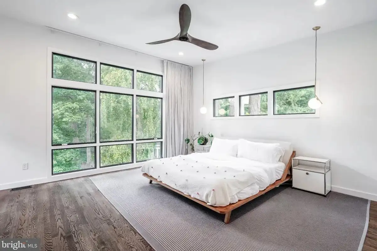 The primary bedroom with floor-to-ceiling windows. 